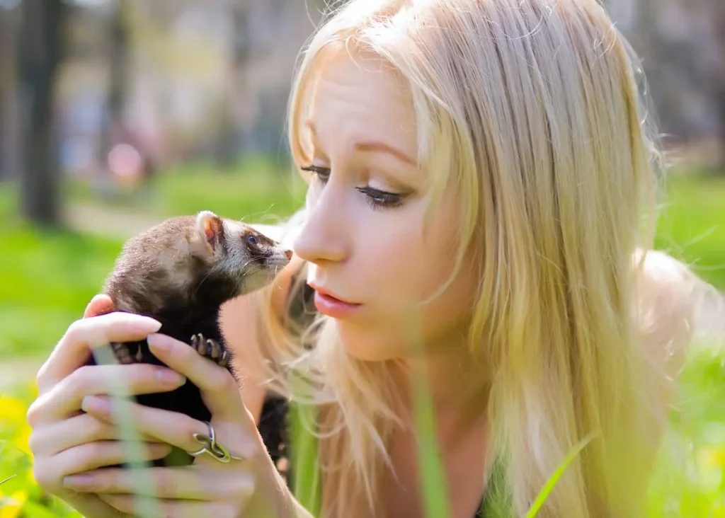 woman holding a ferret